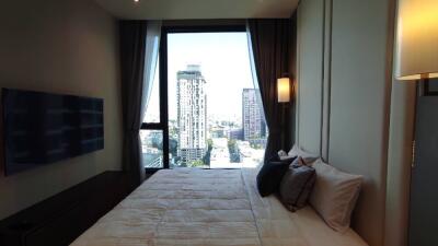 Modern bedroom with large window and city view