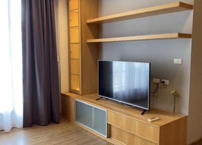 Modern living room with wooden TV stand and shelving