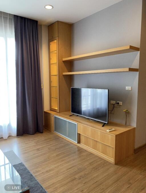 Modern living room with wooden TV stand and shelving