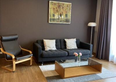 Modern living room with dark sofa and artwork