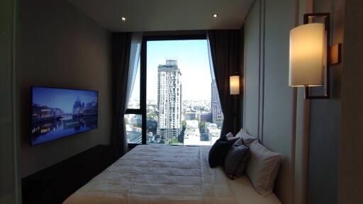 Modern bedroom with a large window view of the city