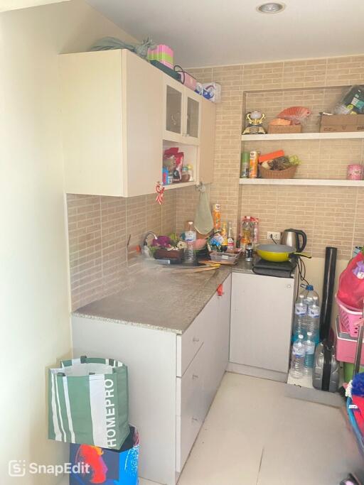 Small kitchen with shelving and tiled backsplash