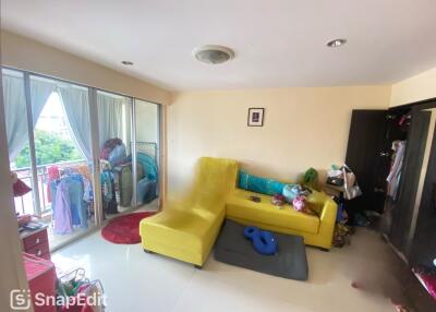 Living room with yellow sofa and balcony access