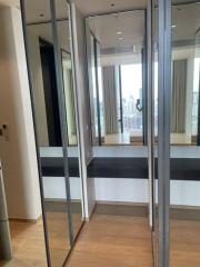 Modern dressing area with mirrored sliding doors