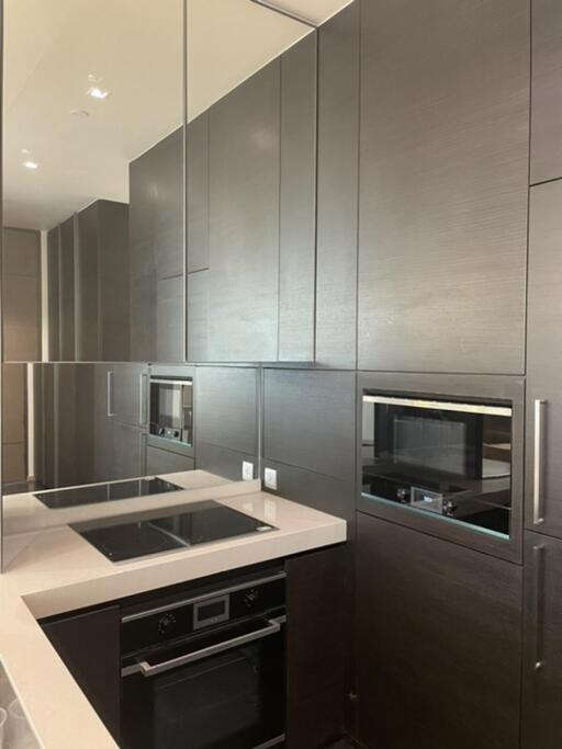 Modern kitchen with dark cabinets and integrated appliances