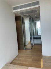 Hallway with wooden flooring and mirrored closet doors