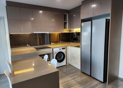 Modern kitchen with integrated appliances and breakfast bar