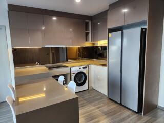 Modern kitchen with integrated appliances and breakfast bar