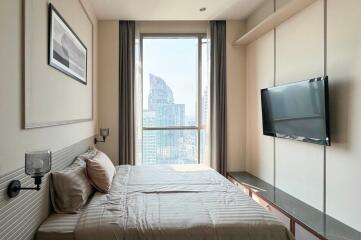 Modern bedroom with a large window and city view