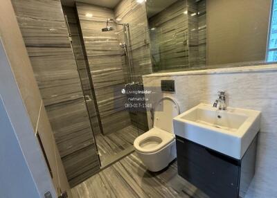 Modern bathroom with large mirror and glass shower enclosure