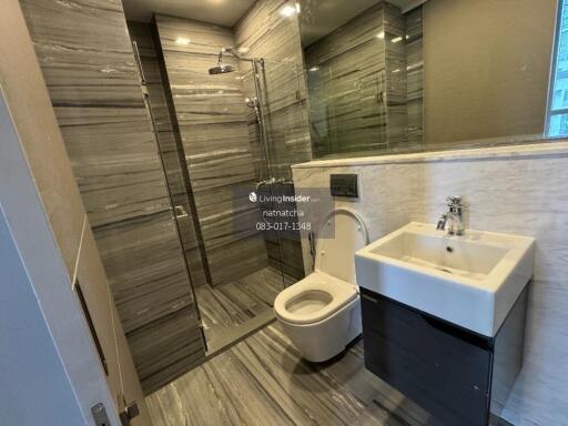 Modern bathroom with large mirror and glass shower enclosure