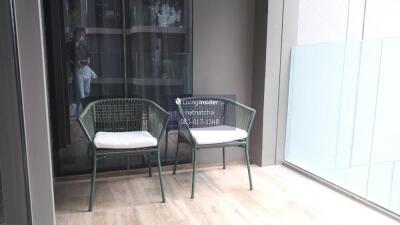 Balcony with two chairs and glass railing