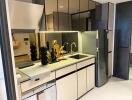 Modern kitchen with stainless steel appliances and under-cabinet lighting