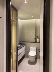 Modern bathroom with toilet, vanity, and mirror