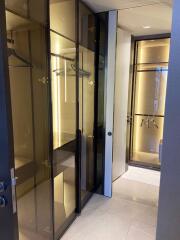 Spacious walk-in closet with glass doors and shelving