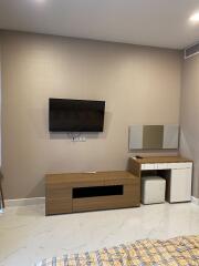 Modern bedroom with wall-mounted TV and dresser