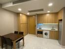 Modern kitchen area with wooden cabinetry and dining space