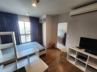 Modern bedroom with window, bed, shelves, TV, and air conditioner