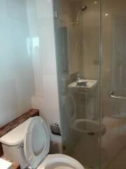 Bathroom with glass-enclosed shower and toilet