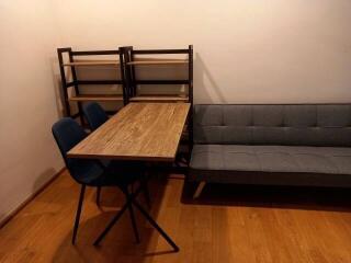 Cozy living room with a wooden table, chairs, sofa and shelves