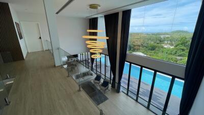 Spacious and modern living area with large windows and pool view