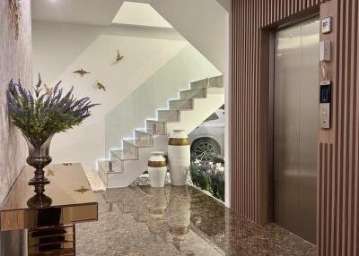 Well-lit building lobby with decorative elements and elevator