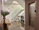 Well-lit building lobby with decorative elements and elevator