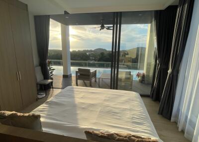 Bedroom with a view of the pool and scenic outdoor area