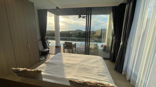 Bedroom with a view of the pool and scenic outdoor area