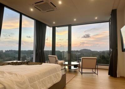 Bedroom with large windows and scenic view