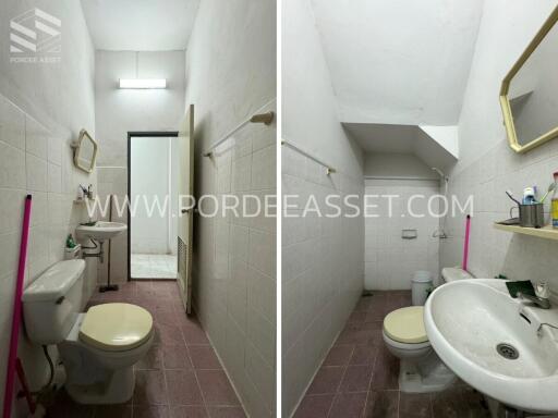 A small bathroom with basic amenities including a toilet, sink, and mirror