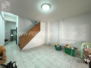 Unfurnished living room with tiled floor and stairway