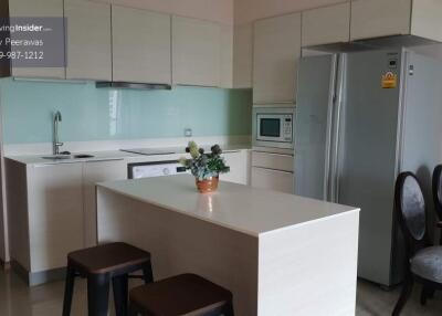 Modern kitchen area with island and built-in appliances