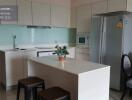 Modern kitchen area with island and built-in appliances