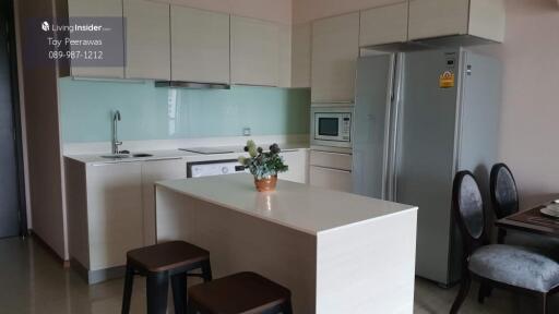 Modern kitchen area with island and built-in appliances