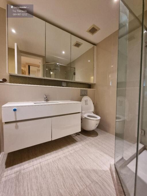 Modern bathroom with large mirrors and glass shower