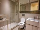 Modern bathroom with glass-enclosed shower, toilet, and sink