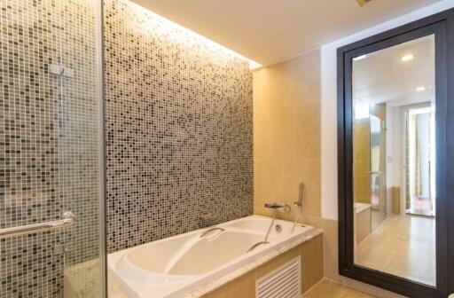 Modern bathroom with bathtub and glass shower