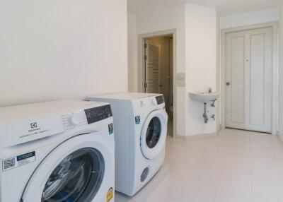 Laundry room with washing machines and sink