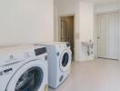 Laundry room with washing machines and sink