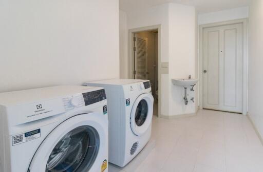 Laundry room with washing machines and sink