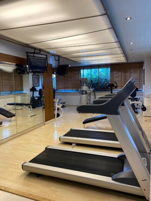 Modern fitness room with treadmills and exercise equipment