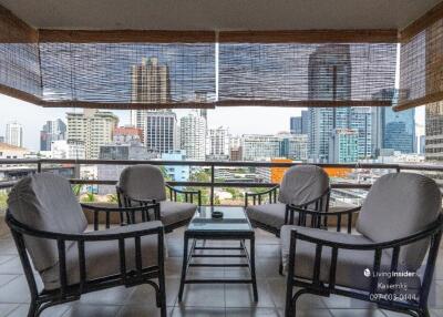 City skyline view from a balcony with comfortable seating