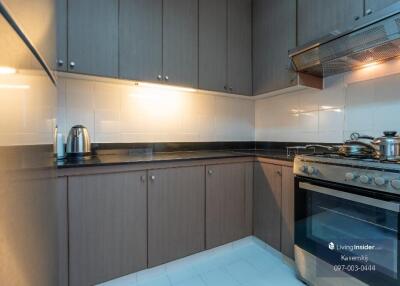 Modern kitchen with wooden cabinetry and stainless steel appliances