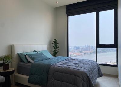 Modern bedroom with large window and city view