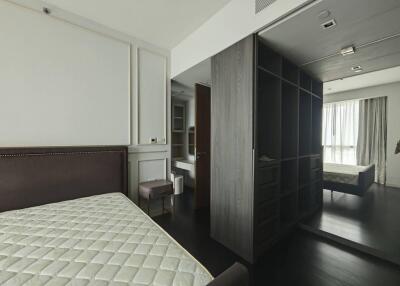 Bedroom with a bed, closet, and large window