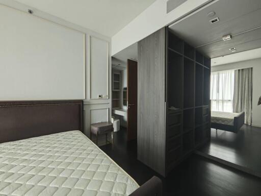 Bedroom with a bed, closet, and large window