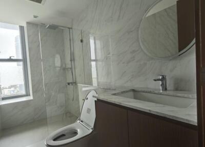 Modern bathroom with marble tiles and glass shower