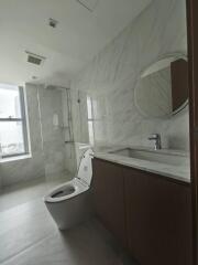 Modern bathroom with marble tiles and glass shower