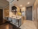 Modern kitchen with dining area, sleek cabinetry, and contemporary lighting